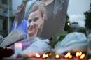 Floral tributes and candles are placed by a picture of murdered Labour MP Jo Cox at a vigil in Parliament Square in London on June 16, 2016