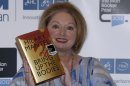 Hilary Mantel, winner of the Man Booker Prize for Fiction, poses for the photographers with a copy of her book 'Bring up the Bodies', shortly after the award ceremony in central London, Tuesday, Oct. 16, 2012. Mantel, won the 50,000 British pounds (80,000 US dollars) prize. (AP Photo/Lefteris Pitarakis)