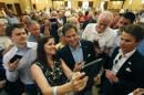Republican presidential candidate Sen. Marco Rubio, R-Fla., takes pictures with people during a campaign event Saturday, July 11, 2015, in Henderson, Nev. (AP Photo/John Locher)