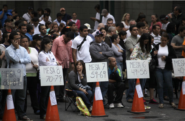 People wait in line to vote in the presidential election at a polling station in Caracas, Venezuela, Sunday, Oct. 7, 2012. President Hugo Chavez is running against opposition candidate Henrique Capril
