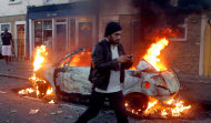 A car is seen on fire in Hackney, east London, as rioters were rampaging across London, Monday, Aug. 8, 2011. Violence and looting spread across some of London's most impoverished neighborhoods on Monday, with youths setting fire to shops and vehicles, during a third day of rioting in the city that will host next summer's Olympic Games. (AP Photo/PA, Lewis Whyld) UNITED KINGDOM OUT, NO SALES, NO ARCHIVE