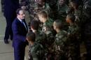 French President Francois Hollande, left, addresses the troops during a stopover from South Africa in Bangui, Central African Republic, Tuesday Dec. 10, 2013. Two French soldiers were killed in combat overnight since France stepped up its presence to restive the former French colony to help quell inter-religious violence. (AP Photo/Jerome Delay)