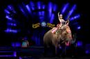 A performer waves as she rides an elephant during a performance in Ringling Bros and Barnum & Bailey Circus' "Circus Extreme" show at the Mohegan Sun Arena at Casey Plaza in Wilkes-Barre, Pennsylvania, U.S.
