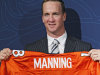 New Denver Broncos quarterback Peyton Manning holds a Broncos jersey with his name and number at the conclusion of an NFL football news conference at the Broncos headquarters in Englewood, Colo.,  on Tuesday, March 20, 2012.  (AP Photo/Ed Andrieski)
