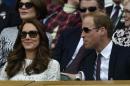 Prince William (R), the Duke of Cambridge, and his wife Catherine, the Duchess of Cambridge, attend a match at the 2014 Wimbledon Championships in southwest London, on July 2, 2014