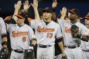 Orioles Tolleson, Machado, and Betemit celebrate defeating the Blue Jays during their MLB American League baseball game in Toronto