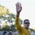 Lance Armstrong waves to the crowd following a run with his fans at Mount Royal park in Montreal