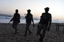 Ivorian soldiers walk on the beach after heavily armed gunmen opened fire on March 13, 2016 at a hotel in the Ivory Coast beach resort of Grand-Bassam