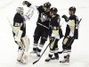 Pittsburgh Penguins goaltender Fleury is congratulated by teammates after his NHL hockey game victory against the Washington Capitals in Pittsburgh