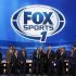 Freer stands on stage with Fox Sports television personalities in New York