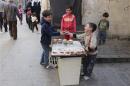 A child sells cake in Old Aleppo