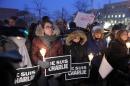 People gather for a vigil January 7, 2015, outside City Hall in Montreal, Canada, for the victims of the shooting at the office of the French satirical magazine Charlie Hebdo