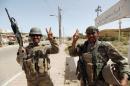 Iraqi soldiers gesture in center of Falluja
