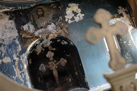 Damaged frescoes are pictured following a service at St. Elijah Church in Istanbul