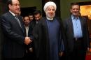 Iranian President Hassan Rouhani (centre) greets Nuri al-Maliki (left) in Tehran on December 5, 2013