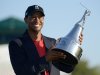 Tiger Woods hoists the championship trophy after winning the Arnold Palmer Invitational golf tournament at Bay Hill in Orlando, Fla., Sunday, March 25, 2012. (AP Photo/Phelan M. Ebenhack)