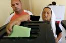 Albanians cast their ballots in local elections at a polling station in the village of Surrel, near Tirana, on June 21, 2015