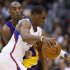 Los Angeles Clippers' Chris Paul dribbles the ball as Los Angeles Lakers' Kobe Bryant defends him during the second half of their NBA basketball game in Los Angeles