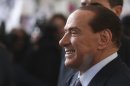 FILE - In this file photo taken Dec. 29, 2012 Silvio Berlusconi smiles as he arrives at Milan's central train station, Italy. Italy's top court confirmed Thursday, Aug. 1, 2013 Berlusconi tax fraud conviction, and ordered the review of a political ban contained in the sentence that was appealed by the Italian media Mogul. (AP Photo/Luca Bruno, file)