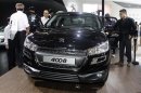 Visitors and journalists look at the Peugeot 4008 at Auto China 2012 in Beijing