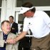 Phil Mickelson visits with former president George H.W. Bush after completing the third round of the Houston Open golf tournament, Saturday, March, 30, 2013, in Humble, Texas. (AP Photo/Patric Schneider)