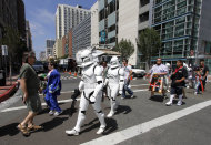 FILE - In this July 23, 2010 file photo, Comic-Con attendees dressed in Star Wars costumes cross the street in downtown San Diego outside of Comic-Con International in San Diego. The 2011 Comic Con International opens Thursday, July 21, 2011. (AP Photo/Denis Poroy, file)