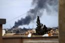 Smoke rises from the port of the eastern Libyan city of Benghazi during clashes between forces loyal to the internationally recognised government and Islamist militias on February 14, 2015
