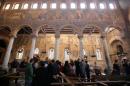 Egyptian security officials and investigators inspect the scene following a bombing inside Cairo's Coptic cathedral in Egypt