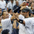 New York Yankees' Jorge Posada, right, high-fives with Derek Jeter and hitting coach Kevin Long, bottom left, after Posada's grand slam during the fifth inning of a baseball game against the Tampa Bay Rays, Saturday, Aug. 13, 2011, at Yankee Stadium in New York. (AP Photo/Bill Kostroun)