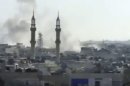 This image made from amateur video released by the Shaam News Network and accessed Tuesday, April 17, 2012, purports to show smoke rising from buildings in Homs, Syria. The Syrian regime widened shelling attacks on opposition strongholds Tuesday, activists said, targeting a second town in a new sign that a U.N.-brokered cease-fire is quickly unraveling despite the presence of foreign observers. (AP Photo/Shaam News Network via AP video) TV OUT, THE ASSOCIATED PRESS CANNOT INDEPENDENTLY VERIFY THE CONTENT, DATE, LOCATION OR AUTHENTICITY OF THIS MATERIAL