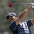 Tiger Woods of the U.S. hits from the 12th fairway during first round play in the 2013 WGC-Cadillac Championship PGA golf tournament in Doral