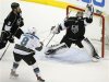 Kings' goalie Jonathan Quick makes a save in the final seconds of their game as Greene and Sharks' Pavelski look on during Game 7 of their Western Conference semi-final hockey playoff in Los Angeles