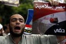 FILE - In this Friday, Sept. 23, 2011 file photo, an Egyptian man chants slogans and holds a poster that reads, in Arabic, "Islamic Egypt," during a demonstration held by a Salafi group to protest the emergency law, in Tahrir Square in Cairo, Egypt. Under Mubarak, there were no mass killings along the lines of South African or some Latin American dictatorships in the 1980s. But tens of thousands of political prisoners were detained under emergency laws that expired last week after 31 years in force. Torture was systematic, and often extreme, and corruption was completely endemic. (AP Photo/Khalil Hamra, File)
