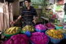 A Palestinian vendors displays food, including pickled vegetables and olives, in preparation for Ramadan at a market in the West Bank city of Hebron, Saturday, June 28, 2014. Muslims throughout the world are preparing themselves for the holy month of Ramadan, when the observant fast from dawn till dusk. (AP Photo/Majdi Mohammed)