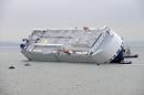 Rescue craft float next to the grounded Hoegh Osaka cargo ship on the Bramble Bank in between Southampton on the southern English coast and the Isle of Wight on January 4, 2015
