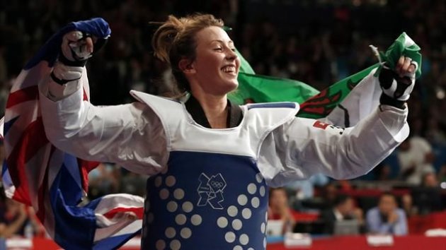 Britain's Jade Jones celebrates with an Union flag (L) and the flag of Wales after winning her women's -57kg gold medal taekwondo match against China's Hou Yuzhuo at the London 2012 Olympic Games (Reuters)