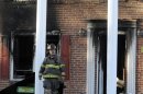 A firefighter exits the front of a heavily damaged two story home where a Special Forces soldier died trying to rescue his 2 small children during a house fire early Tuesday, March 6, 2012 in Hope Mills, N.C.. Mother Louise Cantrell, 37, was injured in the blaze that started around 2:00 am. Edward Duane Cantrell, 36, and his daughters, 6-year old Isabella Cantrell and 4-year old Natalia Cantrell all perished in the fire. (AP Photo/The Fayetteville Observer, Marcus Castro) MANDATORY CREDIT