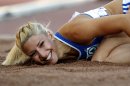 FILE- Greece's Voula Papachristou lands in the sand after her jump at the Women's Triple Jump final at the European Athletics Championships in Helsinki, Finland, in this file photo dated Friday, June 29, 2012. The Hellenic Olympic Committee has removed triple jumper Voula Papachristou from the team taking part in the upcoming London Olympic Games over comments she made on twitter making fun of African immigrants and expressing support for a far-right party. 