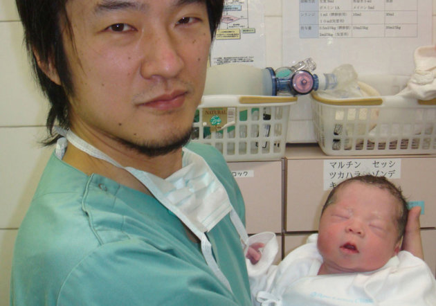 In this Dec. 28, 2012 photo provided by Dr. Kazuhiro Kawamura of the St. Marianna University School of Medicine in Kawasaki, Japan, Kawamura holds a newborn baby whose 30-year-old mother was treated for primary ovarian insufficiency, sometimes called premature menopause, in Tokyo. The mother was one of the five women out of 27 treated who were able to produce usable eggs for in vitro fertilization, Kawamura said. The new technique, described in a report published Monday, Sept. 30, 2013 by the Proceedings of the National Academy of Sciences, raises the promise of a woman with the condition having a baby with her own eggs. (AP Photo/Kazuhiro Kawamura)