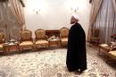 Iranian President Hassan Rouhani waits to meet with Russian Foreign Minister in Tehran on December 11, 2013