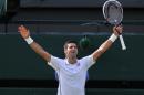 Serbia's Novak Djokovic celebrates winning his men's singles final match against Switzerland's Roger Federer on day thirteen of the 2014 Wimbledon Championships at The All England Tennis Club in Wimbledon, southwest London, on July 6, 2014