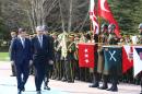Turkish Prime Minister Ahmet Davutoglu (L) and Northern Cyprus Turkish Republic Prime Minister Omer Soyer Kalyoncu review a military honour guard in Ankara on March 2, 2016