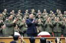 Military officials applaud together with North Korean leader Kim Jong-un, during the Unhasu concert in Pyongyang