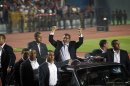 Egyptian President Mohammed Morsi waves to the crowd gathered in a stadium upon his arrival for a speech on the 6th of October national holiday marking the 1973 war with Israel, Cairo, Egypt, Saturday, Oct. 6, 2012.(AP Photo/Khalil Hamra)
