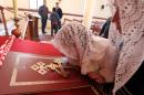 An Assyrian Christian woman and her daughter, who fled the unrest in Syria, attend a prayer for the 220 Assyrian Christians abducted by Islamic State group jihadists at Saint Georges Assyrian Church in Jdeideh, Lebanon, February 26, 2015