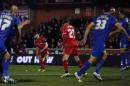 Liverpool's Steven Gerrard, centre, scores his sides second goal from a direct free kick during their English FA Cup third round soccer match between AFC Wimbledon and Liverpool in Kingston, London, Monday, Jan. 5, 2015 . (AP Photo/Alastair Grant)