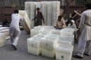 Election workers prepares ballot boxes for transportation to polling stations in Lahore