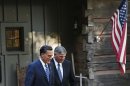 Republican presidential nominee Mitt Romney leaves the home of Reverend Billy Graham with Graham's son Franklin, in Montreat