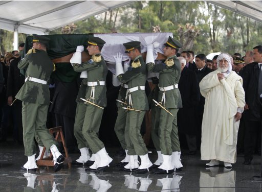 Honour guards carry the coffin of the first President of independent Algeria Ben Bella in Algiers