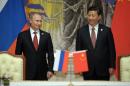 Russia's President Vladimir Putin, and China's President Xi Jinping, right, smile during signing ceremony in Shanghai, China on Wednesday, May 21, 2014. China signed a long-awaited, 30-year deal Wednesday to buy Russian natural gas worth some $400 billion in a financial and diplomatic boost to diplomatically isolated President Vladimir Putin. (AP Photo/RIA Novosti, Alexei Druzhinin, Presidential Press Service)